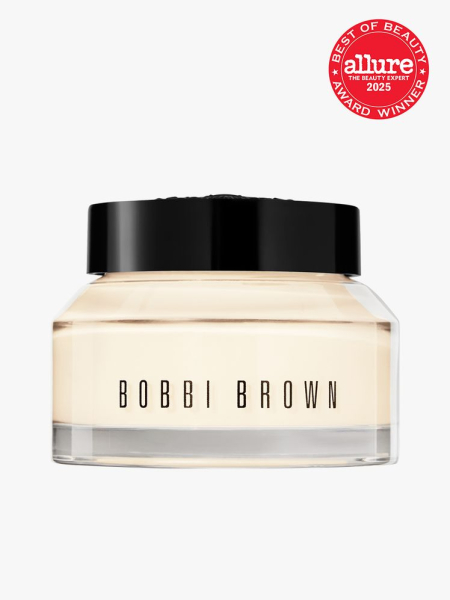 Bobbi Brown Vitamin Enriched Face Base Moisturizer & Primer jar of yellow primer with black cap on light gray background with red Allure Best of Beauty seal in the top right corner